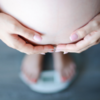 Stock image of woman’s feet on a bathroom scale