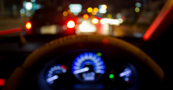 Stock image of an out-of-focus car dashboard at night