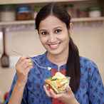 Woman eating vegetable salad.