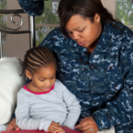 mother reading bedtime story to daugher