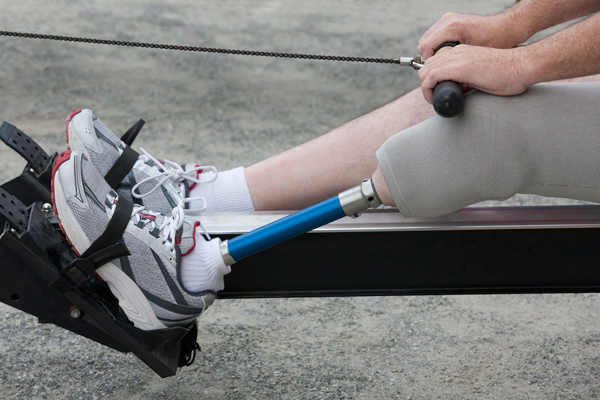 Man with prosthetic on rowing machine