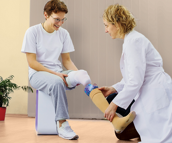 Stock image of a patient receiving a prosthetic device. 