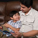 Father reading to son.