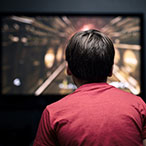 Child in front of a television screen.