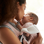 Mother holding newborn infant.