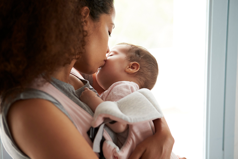 Mother holding newborn infant.