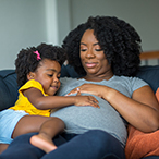 African American pregnant mother and her daughter.