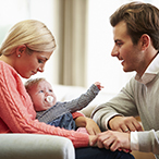 Mother and father with newborn baby.