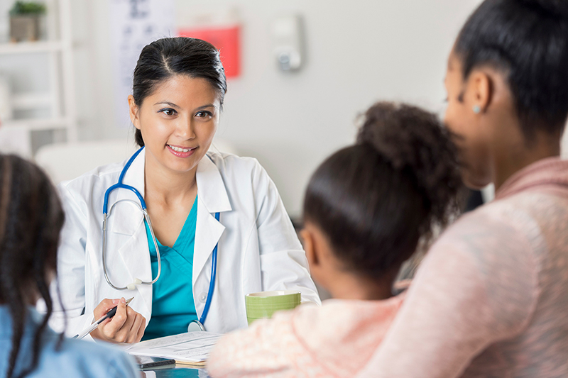 Physician talking to parent and child.