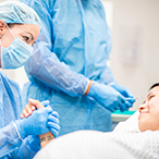 Pregnant woman comforted by health provider.