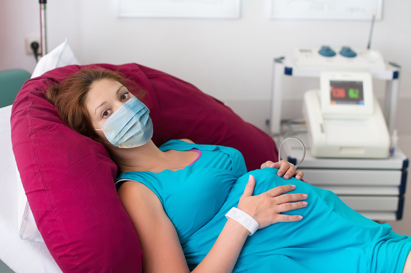 Pregnant woman lying on examining table.