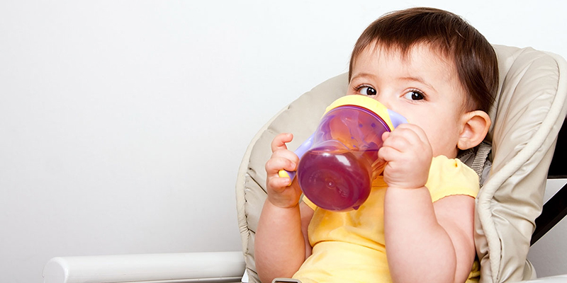 Child drinking from a sippy cup.