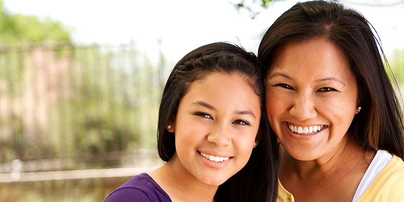 Two young women smiling.