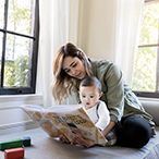 Parent and child looking at a picture book together.