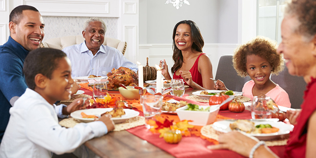 Family sites and eats a meal together.