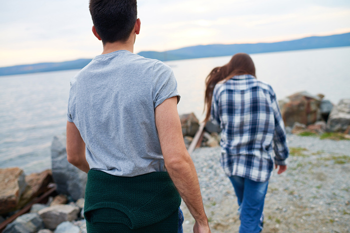 A man follows a young woman.