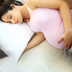Pregnant woman sleeping on her side.