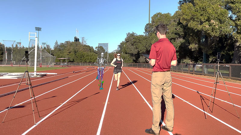 A woman runs on a track toward a man holding a tablet while two smartphones record her motion. An illustration of a moving skeleton appears next to the woman.