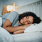 Teen sleeping in a bed.