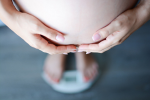 Stock image of woman’s feet on a bathroom scale