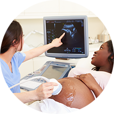 Radiologist showing ultrasound image to a pregnant woman