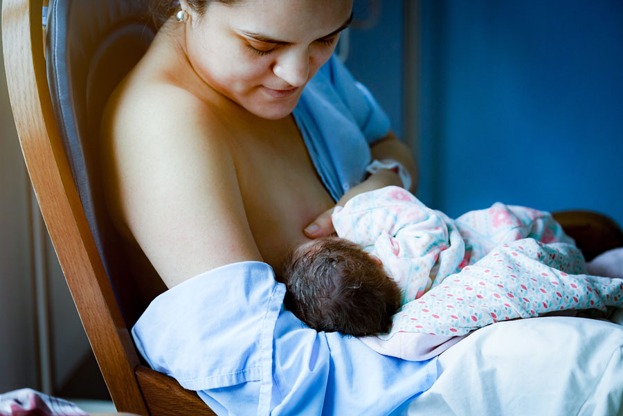 A mother breastfeeding an infant.