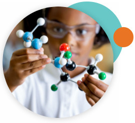 A young girl wearing lab goggles and holding a molecular model.