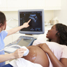 Pregnant woman getting ultrasound.